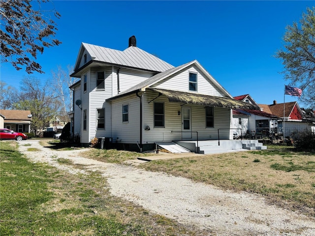 230 Lahaye St, Saint Genevieve, MO 63670 - back of property featuring a chimney, a lawn, and central AC unit
