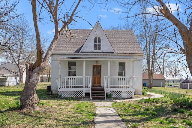 407 N Humboldt St, Marine, IL 62061 - view of front of property with brick siding, a porch, roof with shingles, and central AC