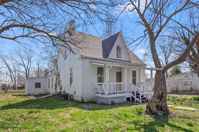 407 N Humboldt St, Marine, IL 62061 - view of front facade with a porch, a shingled roof, a chimney, brick siding, and a front yard