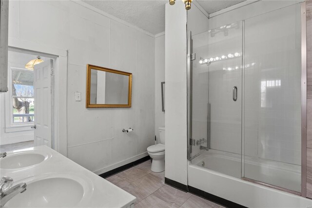 407 N Humboldt St, Marine, IL 62061 - full bathroom with a textured ceiling, toilet, ornamental molding, bath / shower combo with glass door, and double vanity