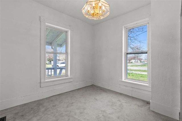 407 N Humboldt St, Marine, IL 62061 - empty room featuring carpet flooring and a chandelier