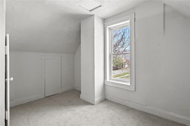 407 N Humboldt St, Marine, IL 62061 - bonus room featuring a textured ceiling, carpet, vaulted ceiling, and baseboards