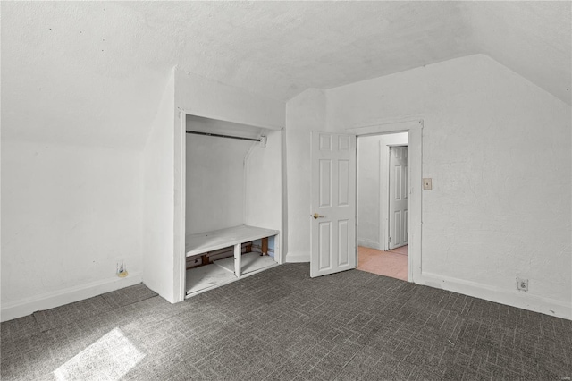407 N Humboldt St, Marine, IL 62061 - unfurnished bedroom featuring lofted ceiling, carpet floors, baseboards, and a textured ceiling