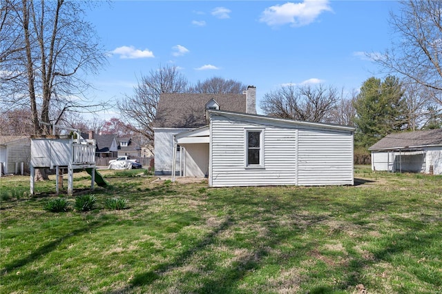 407 N Humboldt St, Marine, IL 62061 - rear view of property featuring a chimney and a lawn