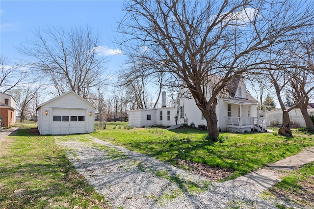 407 N Humboldt St, Marine, IL 62061 - view of front of house with an outbuilding, a detached garage, a front yard, driveway, and covered porch