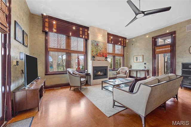 3520 Galt House Dr, Saint Charles, MO 63301 - living area with a ceiling fan, wood finished floors, a large fireplace, and baseboards