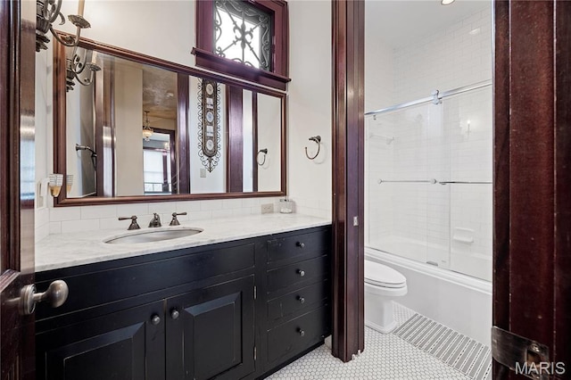 3520 Galt House Dr, Saint Charles, MO 63301 - bathroom with toilet, vanity, combined bath / shower with glass door, tile patterned floors, and tasteful backsplash