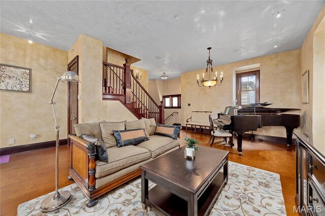 3520 Galt House Dr, Saint Charles, MO 63301 - living room with stairway, wood finished floors, a chandelier, and baseboards