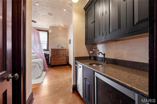 3520 Galt House Dr, Saint Charles, MO 63301 - kitchen featuring wine cooler, a sink, dark stone countertops, and light floors