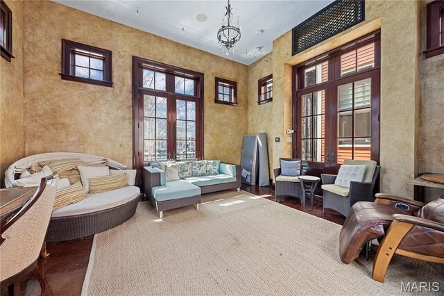 3520 Galt House Dr, Saint Charles, MO 63301 - living area with french doors, a chandelier, and a high ceiling