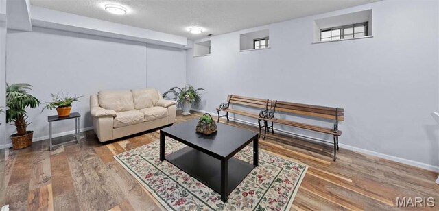 4319 Lindell Blvd Unit A, Saint Louis, MO 63108 - living room with baseboards, wood finished floors, and a textured ceiling