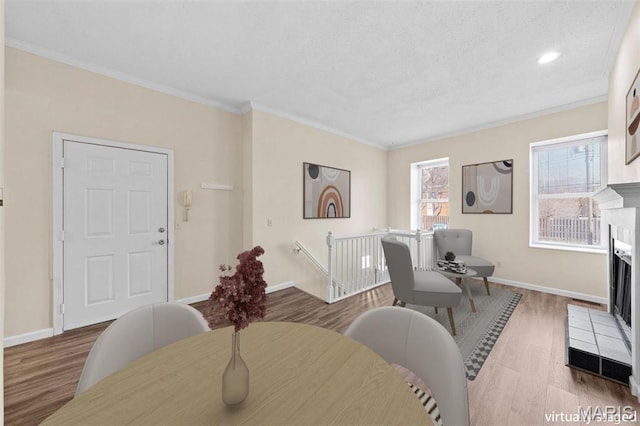 4319 Lindell Blvd Unit A, Saint Louis, MO 63108 - dining area featuring wood finished floors, a tiled fireplace, and crown molding