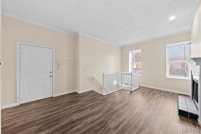 4319 Lindell Blvd Unit A, Saint Louis, MO 63108 - entryway with wood finished floors, a tiled fireplace, and crown molding