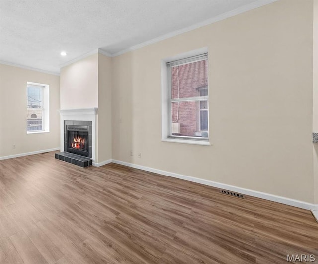 4319 Lindell Blvd Unit A, Saint Louis, MO 63108 - unfurnished living room featuring crown molding, wood finished floors, a fireplace, a textured ceiling, and recessed lighting
