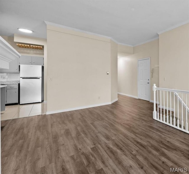 4319 Lindell Blvd Unit A, Saint Louis, MO 63108 - unfurnished living room with crown molding and wood finished floors