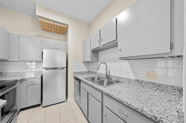 4319 Lindell Blvd Unit A, Saint Louis, MO 63108 - kitchen with appliances with stainless steel finishes, light tile patterned floors, decorative backsplash, and gray cabinetry