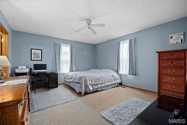 830 Wayne St, Carlyle, IL 62231 - bedroom with carpet flooring, baseboards, an office area, a ceiling fan, and a textured ceiling