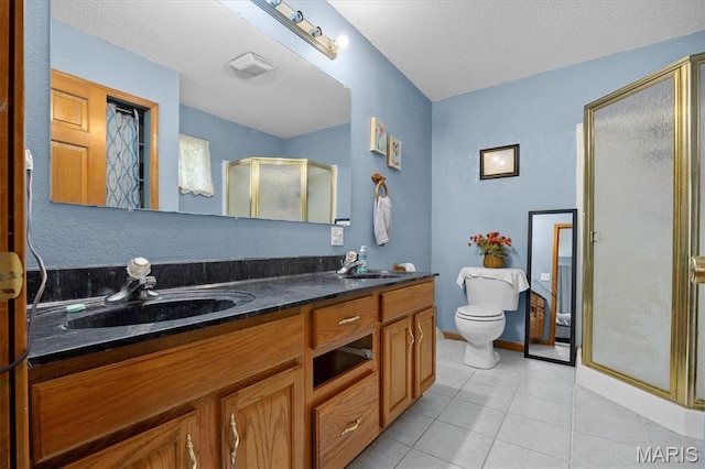 830 Wayne St, Carlyle, IL 62231 - bathroom featuring a stall shower, tile patterned flooring, double vanity, toilet, and a textured ceiling