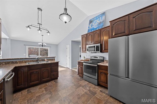 140 Shumard Oak Dr, Troy, MO 63379 - kitchen featuring appliances with stainless steel finishes, a sink, lofted ceiling, a chandelier, and decorative light fixtures