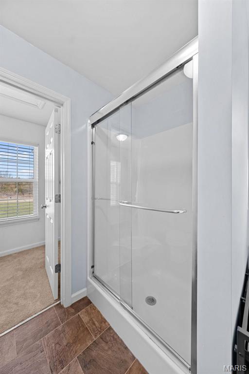 140 Shumard Oak Dr, Troy, MO 63379 - bathroom with a stall shower and baseboards