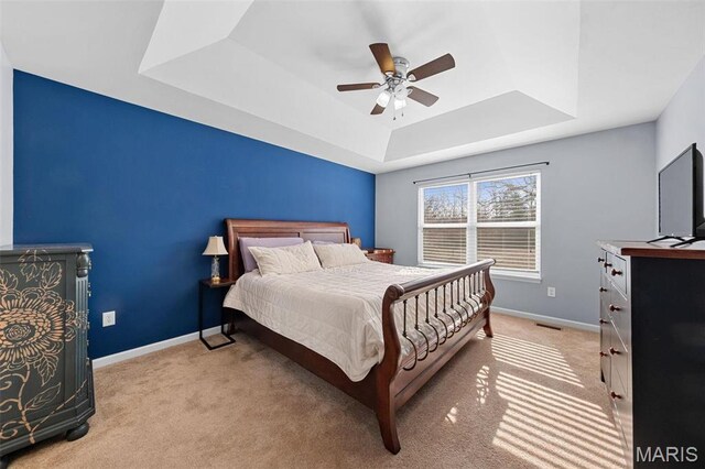 140 Shumard Oak Dr, Troy, MO 63379 - bedroom featuring a raised ceiling, baseboards, light carpet, and a ceiling fan