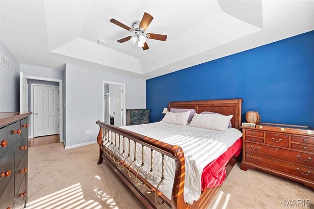 140 Shumard Oak Dr, Troy, MO 63379 - bedroom featuring a raised ceiling, light carpet, baseboards, and ceiling fan