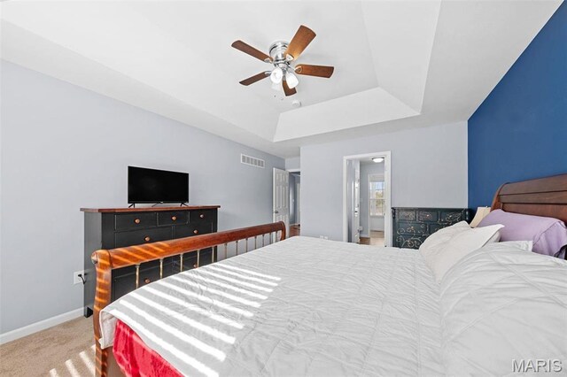 140 Shumard Oak Dr, Troy, MO 63379 - carpeted bedroom featuring a tray ceiling, baseboards, and ceiling fan