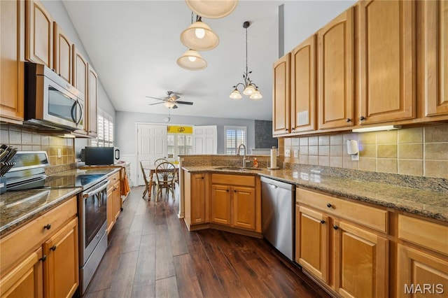 910 Ridgepointe Place Cir, Lake St Louis, MO 63367 - kitchen with appliances with stainless steel finishes, a sink, dark wood-style floors, a ceiling fan, and stone countertops