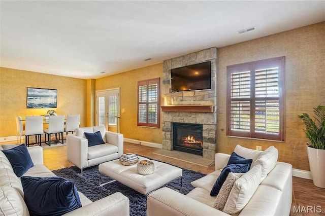 910 Ridgepointe Place Cir, Lake St Louis, MO 63367 - living area featuring a stone fireplace, baseboards, and wood finished floors