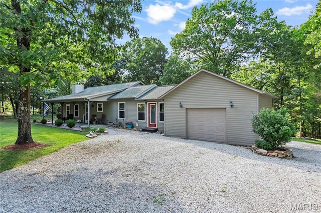 5057 Port Perry Dr, Perryville, MO 63775 - ranch-style home with driveway, a chimney, a garage, and a front lawn