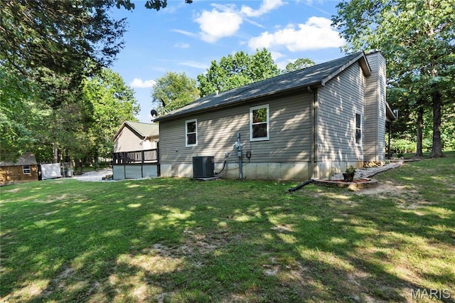 5057 Port Perry Dr, Perryville, MO 63775 - back of house featuring an outbuilding, a chimney, a lawn, central air condition unit, and a shed