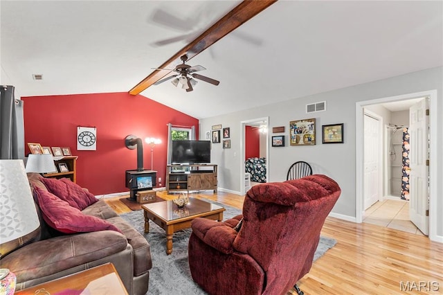 5057 Port Perry Dr, Perryville, MO 63775 - living area with a ceiling fan, light wood finished floors, a wood stove, and baseboards