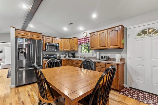 5057 Port Perry Dr, Perryville, MO 63775 - kitchen with stainless steel appliances, a sink, light wood finished floors, brown cabinetry, and light countertops