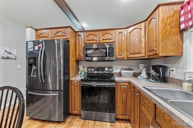 5057 Port Perry Dr, Perryville, MO 63775 - kitchen featuring stainless steel microwave, refrigerator with ice dispenser, electric range, brown cabinets, and beam ceiling
