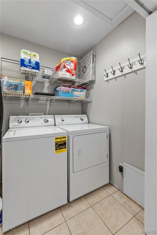 5057 Port Perry Dr, Perryville, MO 63775 - clothes washing area featuring washer and dryer and light tile patterned floors