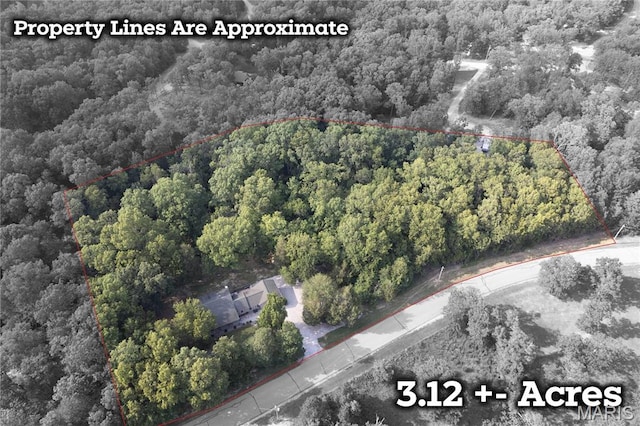 5057 Port Perry Dr, Perryville, MO 63775 - aerial view of property and surrounding area featuring a heavily wooded area and property parcel outlined
