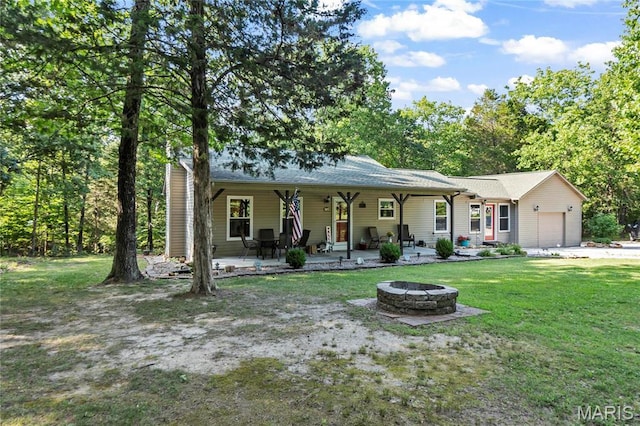 5057 Port Perry Dr, Perryville, MO 63775 - view of front facade with a garage, a fire pit, and a front lawn