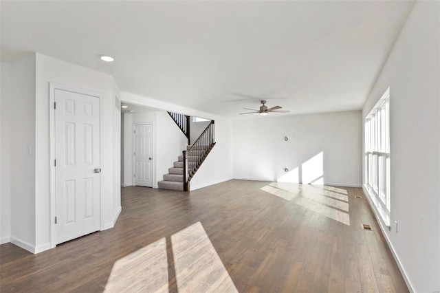 610 Tull Ct, Wentzville, MO 63385 - unfurnished living room with ceiling fan, wood finished floors, stairs, baseboards, and recessed lighting
