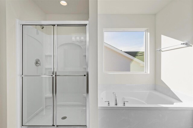 610 Tull Ct, Wentzville, MO 63385 - bathroom with a stall shower, a garden tub, and recessed lighting