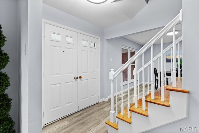 3524 Espace Ct, Florissant, MO 63034 - foyer entrance featuring wood finished floors, stairway, and baseboards