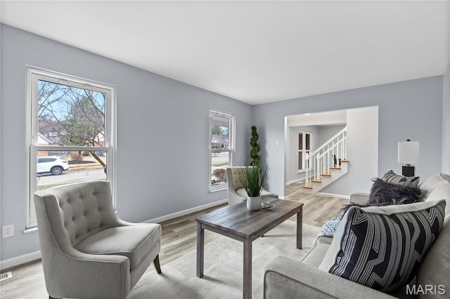 3524 Espace Ct, Florissant, MO 63034 - living room featuring plenty of natural light, stairs, and light wood-type flooring