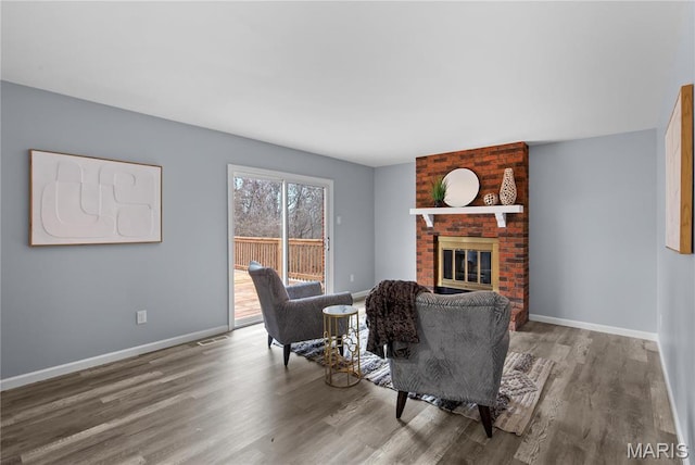 3524 Espace Ct, Florissant, MO 63034 - living room featuring wood finished floors, a fireplace, and baseboards
