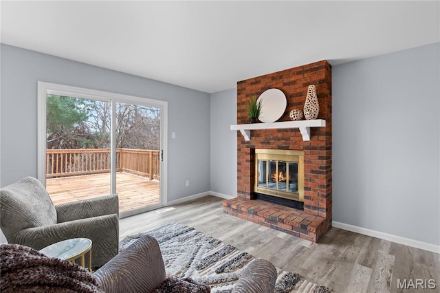 3524 Espace Ct, Florissant, MO 63034 - living area with wood finished floors, a fireplace, and baseboards