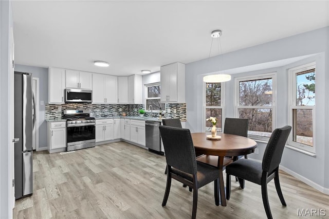 3524 Espace Ct, Florissant, MO 63034 - dining area featuring light wood finished floors and baseboards