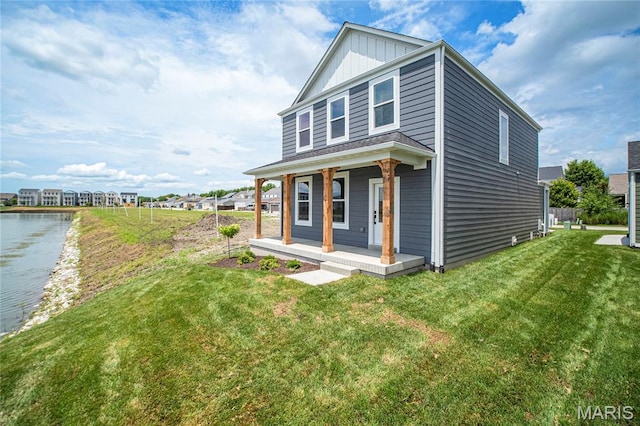 177 Arpent Aly, Saint Charles, MO 63301 - view of front of property with covered porch, board and batten siding, a front yard, and a water view