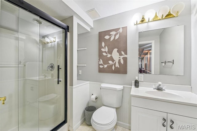 2 Meramec Shores Ct, Ofallon, MO 63366 - full bathroom featuring a stall shower, toilet, vanity, and wainscoting