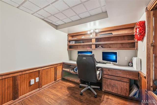 2 Meramec Shores Ct, Ofallon, MO 63366 - home office with built in desk, a wainscoted wall, dark wood-type flooring, and a drop ceiling