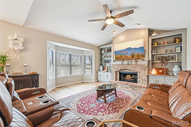 2 Meramec Shores Ct, Ofallon, MO 63366 - living room featuring a ceiling fan, lofted ceiling, wood finished floors, a brick fireplace, and baseboards