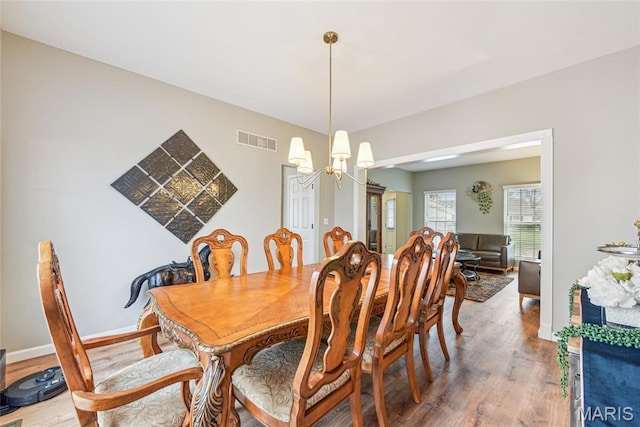 2 Meramec Shores Ct, Ofallon, MO 63366 - dining space featuring wood finished floors, a chandelier, and baseboards