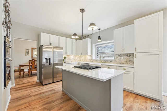 2 Meramec Shores Ct, Ofallon, MO 63366 - kitchen featuring stainless steel refrigerator with ice dispenser, backsplash, light countertops, light wood finished floors, and white cabinets